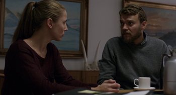 Movie still from “A War” (2015), directed by Tobias Lindholm – A man and a woman sitting at a table; Medium shot, Over the shoulder angle