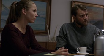 Movie still from “A War” (2015), directed by Tobias Lindholm – A man and a woman sitting at a table; Medium shot, Over the shoulder angle