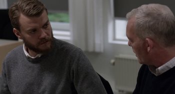 Movie still from “A War” (2015), directed by Tobias Lindholm – Two men sitting in front of each other in front of a window; Close Up shot, Over the shoulder angle
