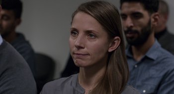 Movie still from “A War” (2015), directed by Tobias Lindholm – A person with long brown hair; Close Up shot, Over the shoulder angle