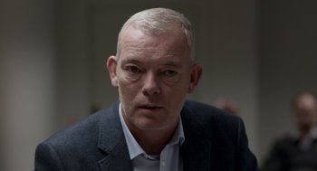 Movie still from “A War” (2015), directed by Tobias Lindholm – A person wearing a jacket; Close Up shot, Over the shoulder angle