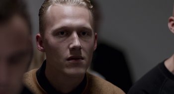 Movie still from “A War” (2015), directed by Tobias Lindholm – A person with blond hair; Close Up shot, Over the shoulder angle