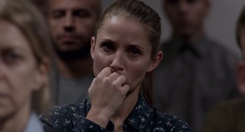 Movie still from “A War” (2015), directed by Tobias Lindholm – A person with her hand to her face; Close Up shot, Over the shoulder angle