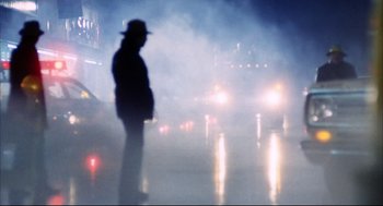 Movie still from “A Woman Under the Influence” (1974), directed by John Cassavetes – A man standing in the middle of a street; Wide shot, Low angle