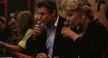 Movie still from “A Woman Under the Influence” (1974), directed by John Cassavetes – A man and a woman drinking wine at a restaurant; Medium shot, Low angle