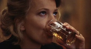 Movie still from “A Woman Under the Influence” (1974), directed by John Cassavetes – A person drinking a glass of beer; Close Up shot, Low angle