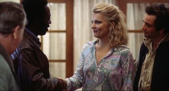 Movie still from “A Woman Under the Influence” (1974), directed by John Cassavetes – Two people are shaking hands in front of a window; Medium shot, Over the shoulder angle