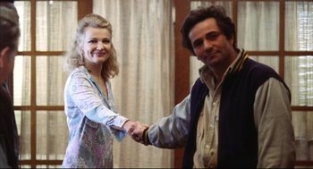 Movie still from “A Woman Under the Influence” (1974), directed by John Cassavetes – A man and a woman shaking hands in front of a window; Medium shot, Low angle
