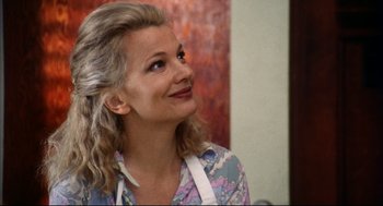 Movie still from “A Woman Under the Influence” (1974), directed by John Cassavetes – A woman in a floral shirt looking up at the sky; Close Up shot, Over the shoulder angle