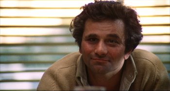 Movie still from “A Woman Under the Influence” (1974), directed by John Cassavetes – A person sitting down with his mouth open; Close Up shot, Low angle
