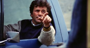 Movie still from “A Woman Under the Influence” (1974), directed by John Cassavetes – A man in a blue car pointing to the side; Close Up shot, Low angle