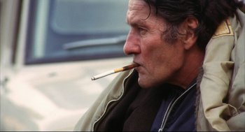 Movie still from “A Woman Under the Influence” (1974), directed by John Cassavetes – A person with a cigarette in his mouth; Close Up shot, Low angle