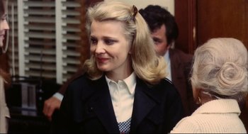 Movie still from “A Woman Under the Influence” (1974), directed by John Cassavetes – A woman in a black jacket and a white shirt; Close Up shot, Over the shoulder angle