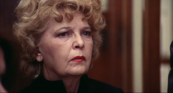 Movie still from “A Woman Under the Influence” (1974), directed by John Cassavetes – An older woman is looking at the camera; Close Up shot, Over the shoulder angle