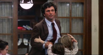Movie still from “A Woman Under the Influence” (1974), directed by John Cassavetes – A man in a brown suit and a red neck tie; Medium shot, Low angle