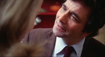 Movie still from “A Woman Under the Influence” (1974), directed by John Cassavetes – A person wearing a suit and tie; Close Up shot, Over the shoulder angle