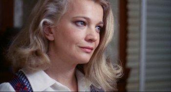 Movie still from “A Woman Under the Influence” (1974), directed by John Cassavetes – A woman with blonde hair wearing a white shirt; Close Up shot, Low angle