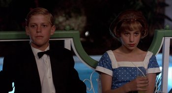 A boy and a girl sitting next to each other