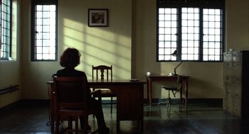 A woman sitting at a table in a room