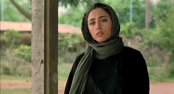 Movie still from “About Elly” (2009), directed by Asghar Farhadi – A woman wearing a black shirt and a green scarf; Close Up shot, Over the shoulder angle