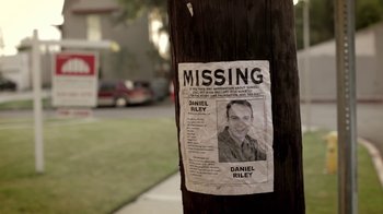 Movie still from “Absentia” (2011), directed by Mike Flanagan – A missing poster on the side of a tree; Wide shot, High angle