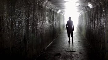 Movie still from “Absentia” (2011), directed by Mike Flanagan – A man is walking in a dark tunnel; Wide shot, Low angle