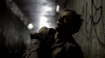 Movie still from “Absentia” (2011), directed by Mike Flanagan – A man in a black shirt is looking into the distance; Close Up shot, Low angle