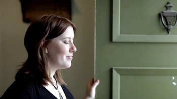 Movie still from “Absentia” (2011), directed by Mike Flanagan – A woman standing in front of a green door; Close Up shot, Low angle
