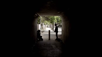 Movie still from “Absentia” (2011), directed by Mike Flanagan – A person standing in a tunnel with trees in the background; Wide shot, Low angle