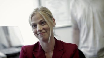 Movie still from “Absentia” (2011), directed by Mike Flanagan – A woman in a red jacket smiling for the camera; Close Up shot, Low angle