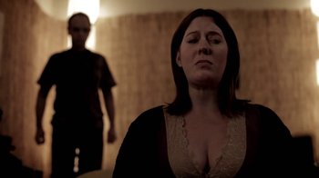 Movie still from “Absentia” (2011), directed by Mike Flanagan – A woman in a black shirt and a man in a black shirt; Medium shot, Over the shoulder angle
