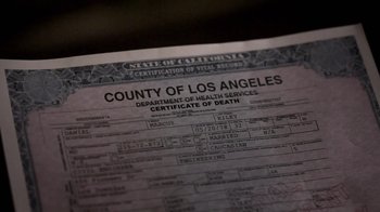 Movie still from “Absentia” (2011), directed by Mike Flanagan – A death certificate is displayed on top of a table; Extreme Close Up shot, Overhead angle