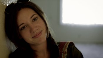 Movie still from “Absentia” (2011), directed by Mike Flanagan – A person smiling for the camera; Close Up shot, Low angle
