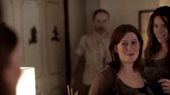 Movie still from “Absentia” (2011), directed by Mike Flanagan – A man and a woman standing next to each other in a room; Medium shot, Over the shoulder angle
