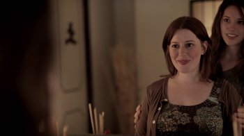 Movie still from “Absentia” (2011), directed by Mike Flanagan – A woman standing in front of a mirror in a room; Close Up shot, Over the shoulder angle