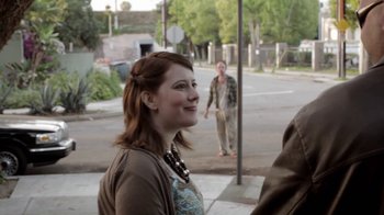 Movie still from “Absentia” (2011), directed by Mike Flanagan – A woman standing on the side of the street; Medium shot, Over the shoulder angle