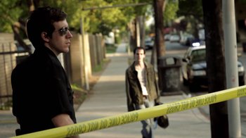 Movie still from “Absentia” (2011), directed by Mike Flanagan – A man standing next to a man on a sidewalk; Medium shot, Low angle
