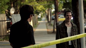 Movie still from “Absentia” (2011), directed by Mike Flanagan – Two young men standing on the side of the street; Medium shot, Over the shoulder angle