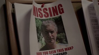 Movie still from “Absentia” (2011), directed by Mike Flanagan – A missing person poster of a man with a missing tooth; Extreme Close Up shot, High angle