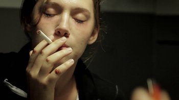 Movie still from “Absentia” (2011), directed by Mike Flanagan – A woman is smoking a cigarette in the dark; Close Up shot, Low angle