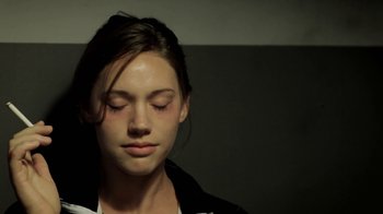 Movie still from “Absentia” (2011), directed by Mike Flanagan – A woman with her eyes closed with her eyes closed; Close Up shot, Over the shoulder angle