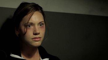 Movie still from “Absentia” (2011), directed by Mike Flanagan – A woman with a black jacket and a white shirt; Close Up shot, Over the shoulder angle