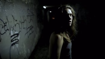 Movie still from “Absentia” (2011), directed by Mike Flanagan – A man with long brown hair standing next to a wall; Medium shot, Low angle