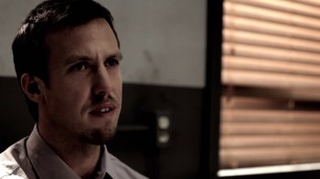 Movie still from “Absentia” (2011), directed by Mike Flanagan – A person wearing a shirt and tie; Close Up shot, Over the shoulder angle