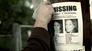 Movie still from “Absentia” (2011), directed by Mike Flanagan – A person holding a missing poster on a pole; Extreme Close Up shot, Overhead angle