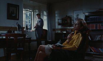 Movie still from “Accident” (1967), directed by Joseph Losey – A man and a woman sitting in front of a window; Medium shot, High angle