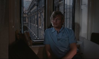 Movie still from “Accident” (1967), directed by Joseph Losey – A man sitting in front of an open window; Medium shot, Over the shoulder angle