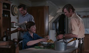 Movie still from “Accident” (1967), directed by Joseph Losey – A woman sitting at a table with a bowl of food; Medium shot, High angle