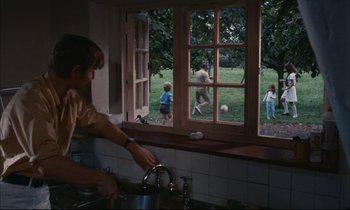 Movie still from “Accident” (1967), directed by Joseph Losey – A group of children playing soccer in a kitchen; Wide shot, High angle