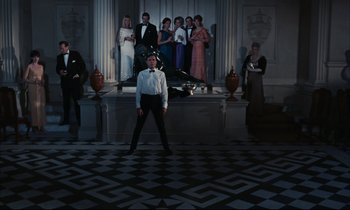 Movie still from “Accident” (1967), directed by Joseph Losey – A group of people standing in front of a building; Wide shot, Low angle